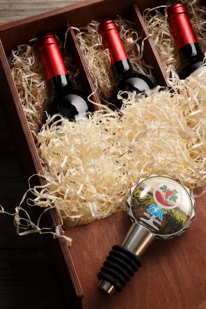 box of wine bottles with a wine stopper that has a custom graphic
