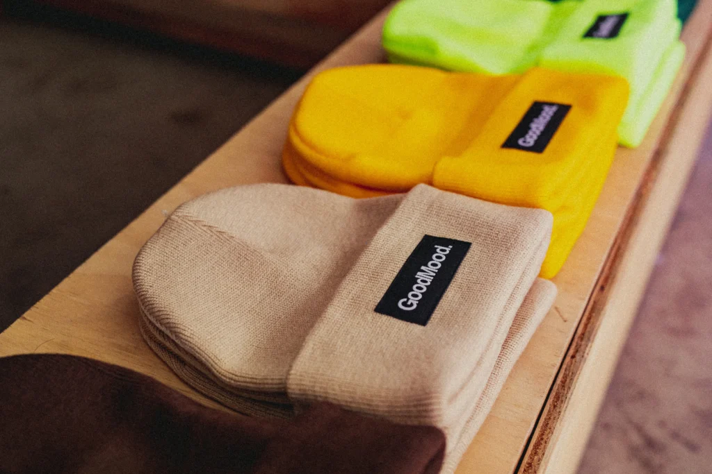 beanies on a table with a custom embroidered patch